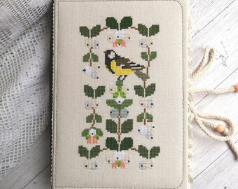 Handmade notebook with cross stitch. Bird and leaves. Sketchbook