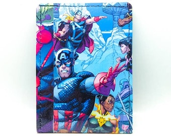 May include: A blue and red wallet with a comic book style image of superheroes, including Captain America, Thor, and other characters. The background is blue and white.