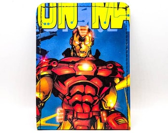 May include: A red and gold Iron Man comic book character wallet. The wallet has a blue background with yellow text that reads "Iron Man".