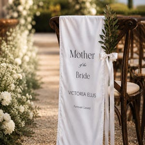 Wedding memorial chair banner displayed in ceremony aisle honoring Mother of the Bride with custom name