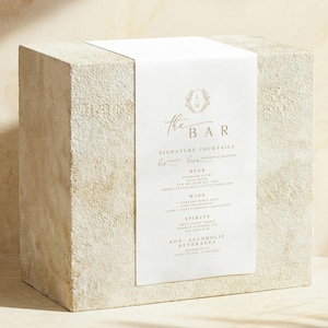 Wedding bar sign on linen fabric styled on a stone pedestal