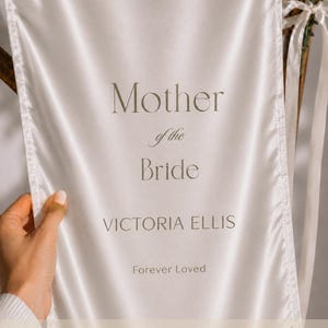 Close up of Mother of the Bride memorial banner on polyester fabric with elegant typography and personalized details