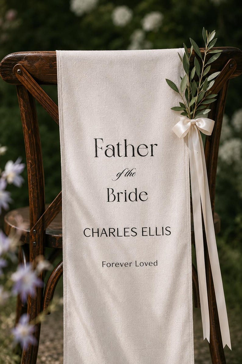 Father of the Bride memorial chair banner displayed outdoors in romantic garden wedding setting