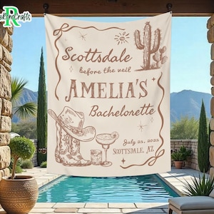 May include: A beige bachelorette party banner with brown text that reads "Scottsdale before the veil Amelia's Bachelorette July 25, 2025 Scottsdale, AZ". The banner also features a drawing of a cowboy hat, boots, a margarita glass, and a cactus.