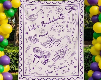 May include: A white blanket with a purple border and illustrations for a bachelorette party. The blanket features a trumpet, mask, and the text "Kate's Bachelorette New Orleans. LA 2026". Balloons in green, purple, and yellow frame the blanket.