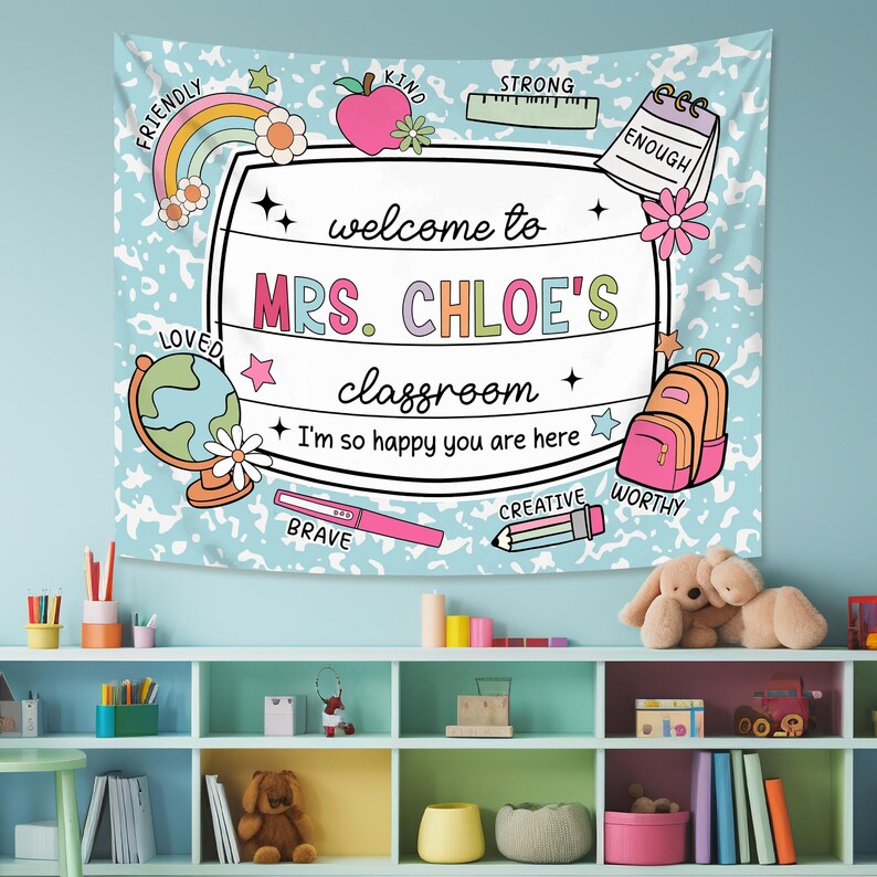 May include: A blue and white classroom tapestry with a welcome sign that says "Welcome to Mrs. Chloe's Classroom." The sign is surrounded by colorful illustrations of school supplies, stars, and the words "Friendly", "Kind", "Strong", "Enough", "Loved", "Brave", "Creative", "Worthy".