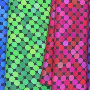 May include: A collection of fabric swatches with a repeating pattern of colorful circles on a black background.