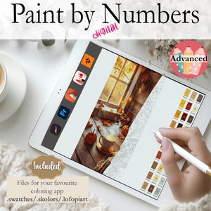 May include: A digital paint by numbers image on a tablet screen. The image is of a cosy autumn scene with a window, a cup of coffee, and autumn leaves. The tablet screen also shows a colour palette and the text "Advanced".