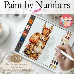 May include: Digital paint by numbers image on a tablet screen featuring a cute cartoon squirrel holding a pumpkin. The image is in shades of brown, orange, and white. The tablet is on a white surface with a cup of coffee and a knitted blanket.