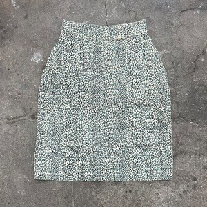 May include: A white skirt with a blue and black leopard print pattern.