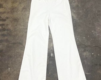 May include: White wide-leg trousers with a high waist and button fastenings.