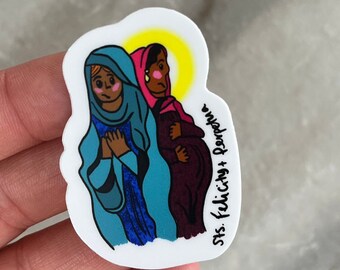 May include: A sticker featuring a colorful illustration of two women in prayer. The woman on the left is wearing a blue robe and the woman on the right is wearing a pink and purple robe. The sticker has the text "Sts. Felicity + Perpetua" written on the bottom right corner.