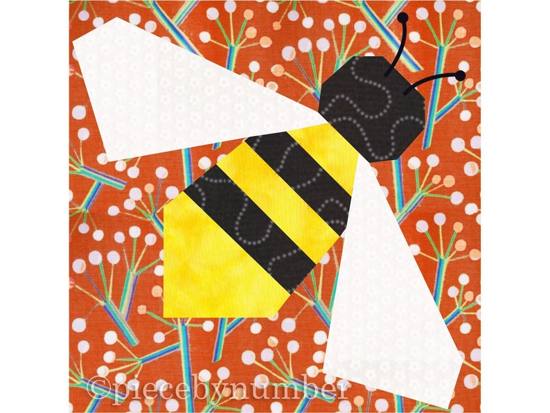 Square quilt block design of a stylized honey bee with embroidered antennae. Bee is yellow and black striped, with cream wings. Background is rust and teal stylized botanical print.