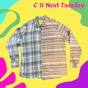 May include: A long-sleeved button-down shirt with a plaid pattern on one side and a striped pattern on the other. The shirt is made of a light-weight fabric and has a relaxed fit.