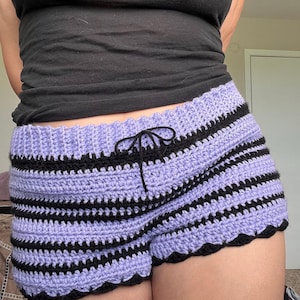 May include: Purple and black striped crochet shorts with a scalloped hem.