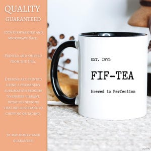 May include: White ceramic mug with a black handle and interior. The mug features the text "EST. 1975 FIF-TEA Brewed to Perfection" in black. The mug is designed for hot beverages and is dishwasher and microwave safe.