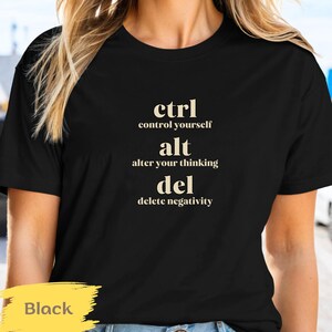 May include: Black t-shirt with the text "ctrl alt del" and the phrases "control yourself", "alter your thinking", and "delete negativity".