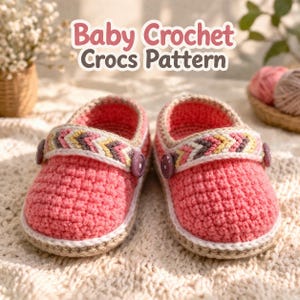 May include: A pair of handmade baby crochet Crocs in pink with a textured stitch. The shoes have a decorative strap with a colorful chevron pattern and purple buttons. The soles are trimmed with a light brown and white border. The text "Baby Crochet Crocs Pattern" is at the top.