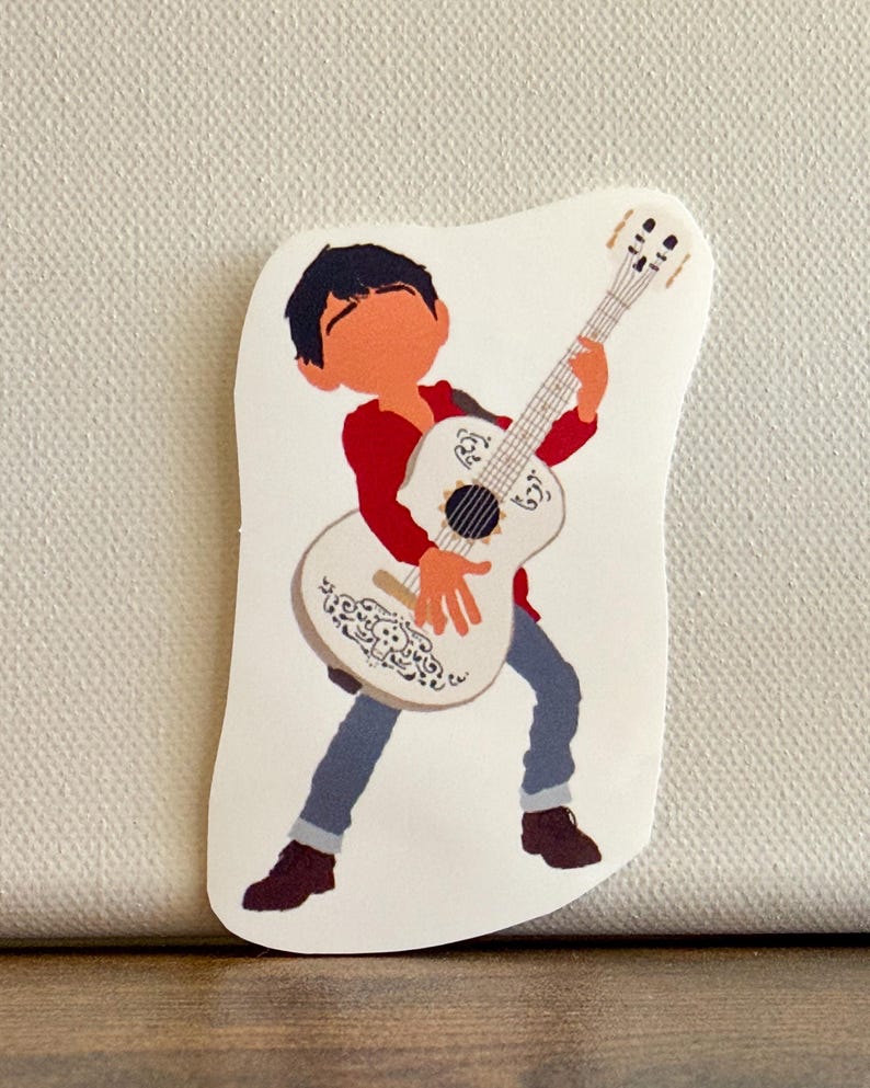 K&ouml;nnte beinhalten: Ein Aufkleber mit einer Cartoon-Illustration eines Jungen, der eine wei&szlig;e Gitarre spielt. Der Junge tr&auml;gt ein rotes Hemd, blaue Hosen und braune Schuhe. Die Gitarre hat ein dekoratives Design.