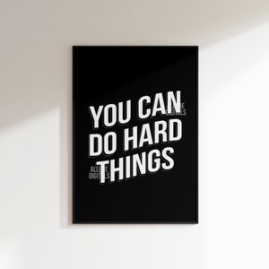 May include: Black and white motivational poster with the text "You can do hard things" in a bold, white font.