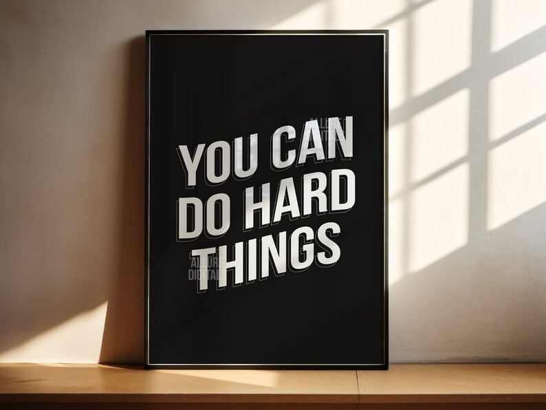 May include: Black and white motivational poster with the text "YOU CAN DO HARD THINGS" in a bold, 3D-style font.