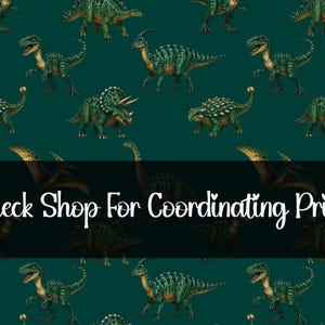 May include: A teal background is covered with illustrations of various green dinosaurs. The dinosaurs are in different poses and species. The text "Check Shop For Coordinating Print" is displayed in white.