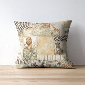 May include: Square decorative pillow with a patchwork design featuring safari animals like lions, giraffes, and zebras. The pillow has a neutral color palette with beige, brown, and green tones, creating a vintage aesthetic. The pillow is placed on a wooden surface.