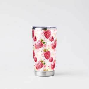 May include: A stainless steel tumbler with a white background and a pattern of red raspberries. The tumbler has a lid and is ideal for keeping drinks cold or hot.