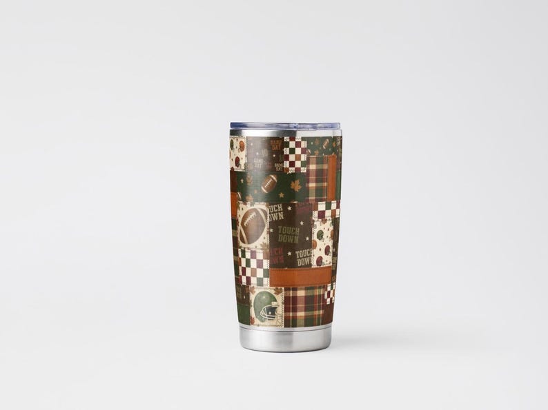 May include: A stainless steel tumbler with a patchwork design featuring footballs, helmets, and the words "Touch Down" in brown, green, and white. The tumbler has a silver base and a dark blue lid. The overall theme is sports.