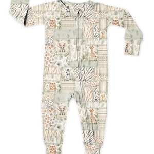 May include: A light-colored baby sleeper with a patchwork design featuring safari animals like lions, giraffes, and elephants. The sleeper has a zipper closure and long sleeves. The color palette includes beige, tan, and green.