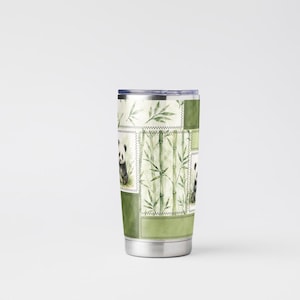 May include: Stainless steel tumbler featuring a patchwork design with panda bears and bamboo stalks. The tumbler has a silver lid and base, and the design incorporates shades of green and white. The overall theme is nature and wildlife.