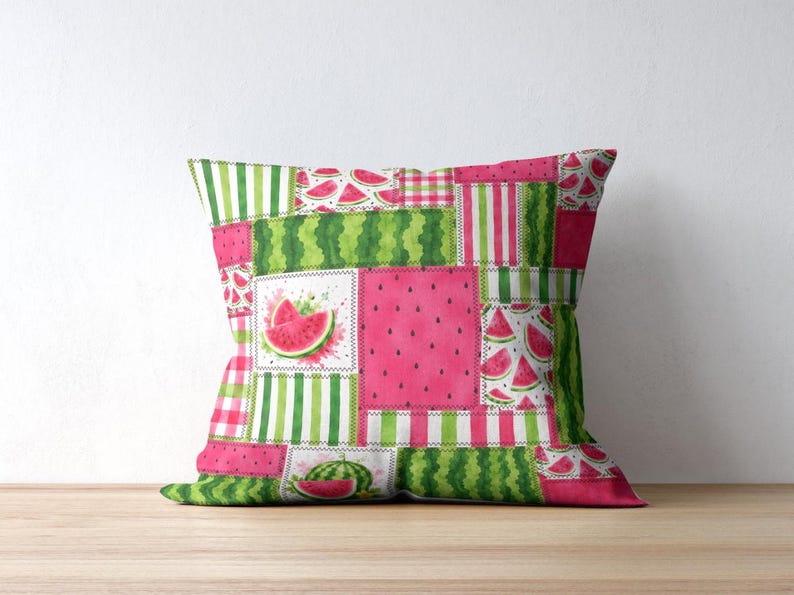 May include: A square throw cushion featuring a patchwork design with various watermelon-themed patterns. The print includes bright pink sections with black seeds, green striped panels, and illustrations of sliced watermelon on a white background.