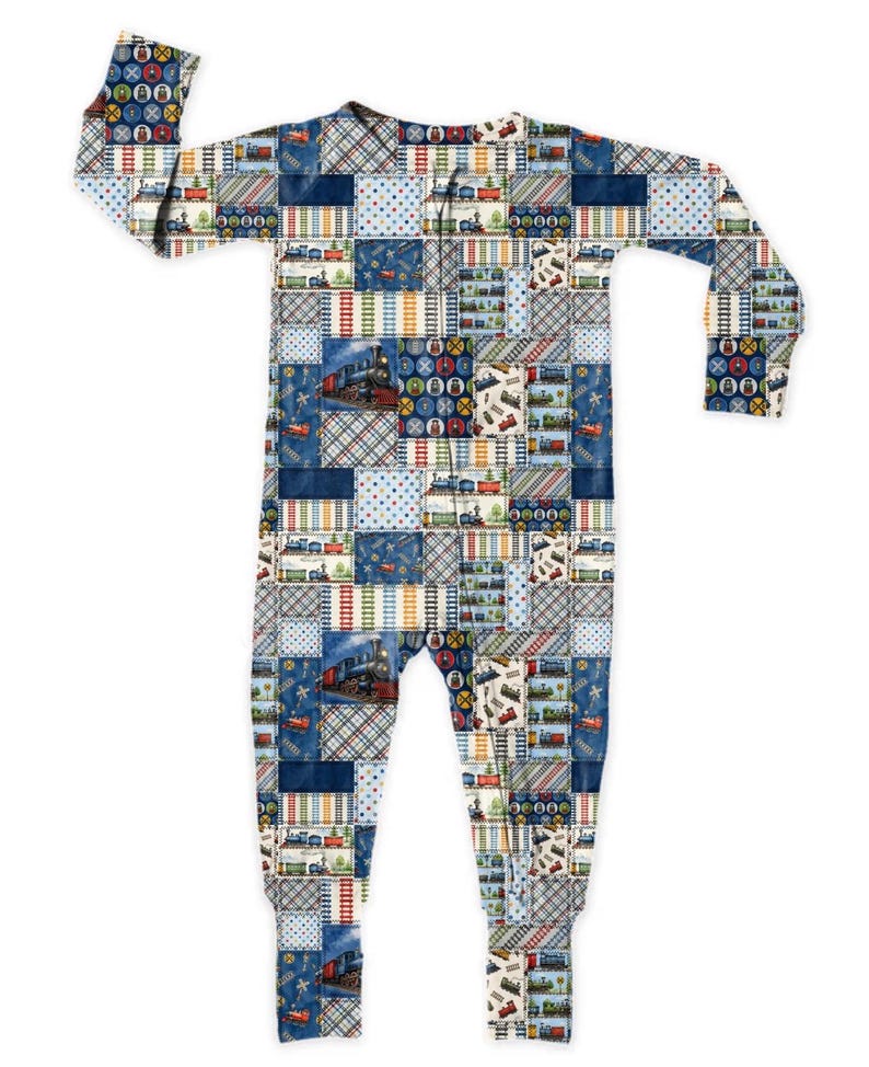 K&ouml;nnte beinhalten: Einteiliger Schlafanzug mit Patchwork-Design mit Z&uuml;gen, Bahn&uuml;berg&auml;ngen und anderen Eisenbahngrafiken. Die Farbpalette umfasst Blaut&ouml;ne, Rot, Gelb und Wei&szlig;. Der Schlafanzug hat lange &Auml;rmel und Fu&szlig;bedeckungen.