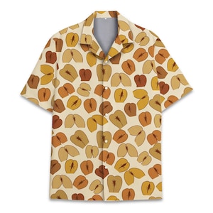 May include: Short-sleeved button-down shirt with a cream background and a repeating pattern of brown and yellow shapes. The shirt features a classic collar and a button-up front.