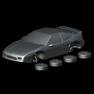 May include: A gray model car with detached wheels, set against a black background. The car has a spoiler and rectangular headlights. Four gray wheels are positioned below the car.