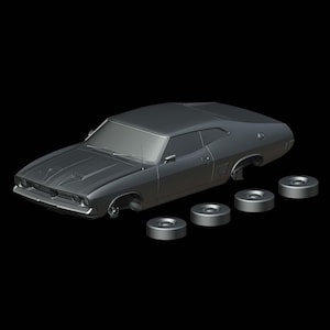 Pode incluir: Modelo de carro clássico cinza com rodas soltas. O carro tem um design elegante com uma entrada de ar no capô e uma frente detalhada. As rodas são circulares e metálicas, em um fundo preto.