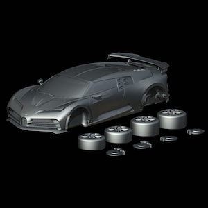 May include: A gray, unpainted model of a sports car with detached wheels and brake discs. The car has a sleek design with a rear spoiler and detailed front grille. The wheels are circular and have a detailed design.