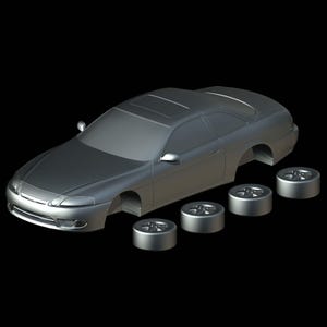 May include: A silver-colored model car with a sunroof and four detached wheels. The car's body is a sleek coupe design, with detailed headlights and side mirrors. The wheels are also silver and have a multi-spoke design.