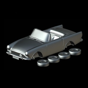 May include: A silver convertible car model with detached wheels. The car has a sleek design with a windshield and open top. The wheels are circular and silver, matching the car's body. The background is black.
