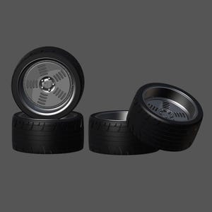 May include: Four black tires with silver rims. The rims have a spoke design.