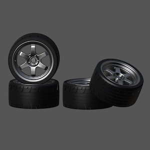 May include: Four black car tires with silver rims are arranged against a gray background. The tires have a tread pattern and the rims have a multi-spoke design. The tires are likely for a car or truck.