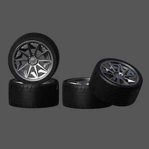 May include: Four black tires with silver rims. The tires are stacked on top of each other. The rims have a multi-spoke design.