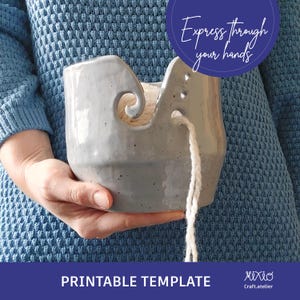 May include: A grey ceramic yarn bowl with a white yarn tail hanging out of the side. The bowl has a hole in the centre for the yarn to pass through. The text "Express through your hands" is visible in the background. Printable template.