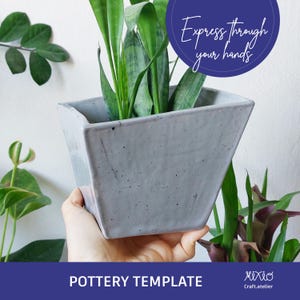 May include: A grey square pottery planter containing a green plant with long, upright leaves. The planter is held by a person. The image includes the text "Express through your hands" and "Pottery Template".