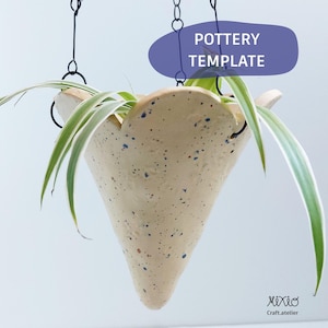 May include: A hanging, cone-shaped planter with a speckled beige finish and blue accents. The planter holds a green and white plant and is suspended by black chains. The text "POTTERY TEMPLATE" is in a purple oval above the planter.
