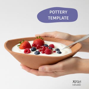 May include: A terracotta-colored pottery bowl filled with yogurt and topped with fresh strawberries, raspberries, blueberries, and red currants. The bowl is held by two hands. The text "POTTERY TEMPLATE" is in a purple oval above the bowl.