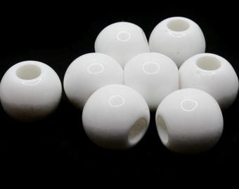May include: Eight white ceramic beads with a hole through the center. The beads are smooth and round.