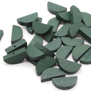 May include: A pile of 20 green wooden half-circle beads with a hole in the center of each bead.