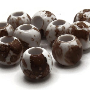 May include: Ten white plastic beads with brown marbling. The beads have a hole through the centre.
