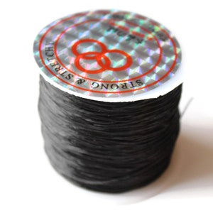 May include: A spool of black elastic string, labeled "STRONG & STRETCHY".